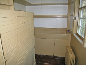 Room 108, the pantry. This small service room to the kitchen still retains its dry sink and shelving. 