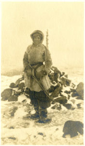 Jessie Luther wearing snowshoes and fawn skin coat, 1909